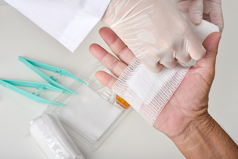 Doctor doing wound dressing care and bandaging patient's hand, Hand surgery treatment, Nurse treat patient's finger injury in hospital. bandages